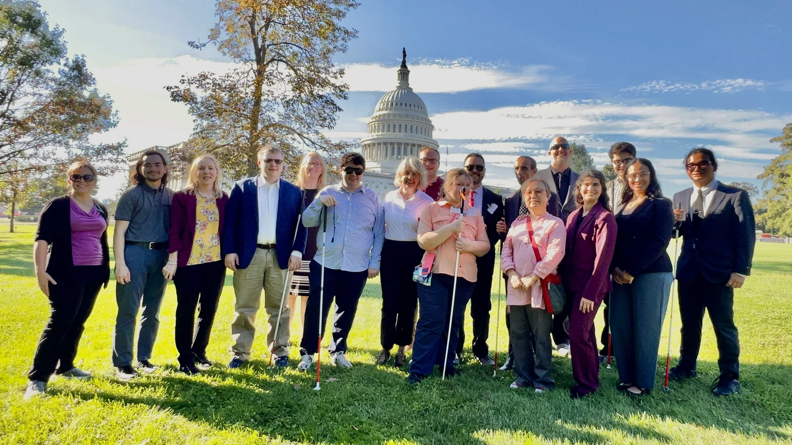 The advocacy group stands on the Capitol lawn beneath a blue sky.