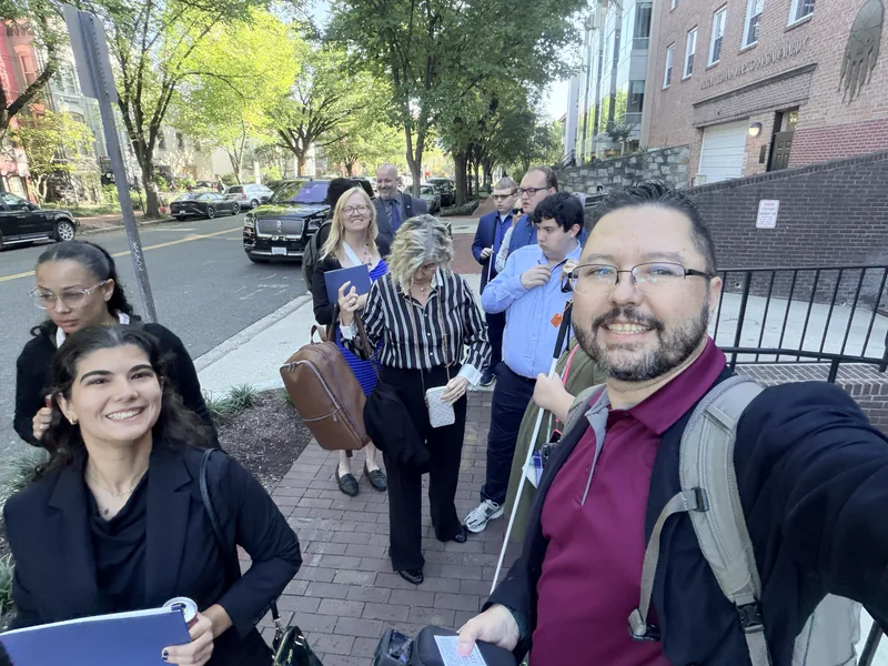Rob takes a group selfie on a tree-lined Washington sidewalk.