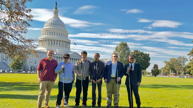 Six members of the group pose together on the Capitol lawn.