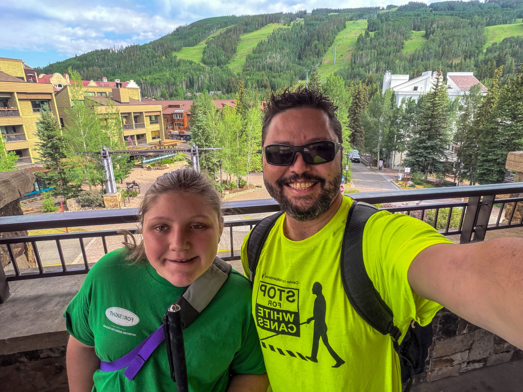 Rob and Isabelle Harris smile together overlooking the mountains in Vail, Colorado.